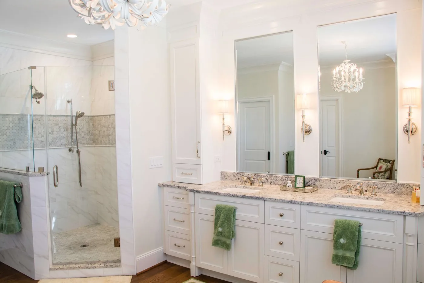 An FFT master bath with a long double vanity and a glass shower