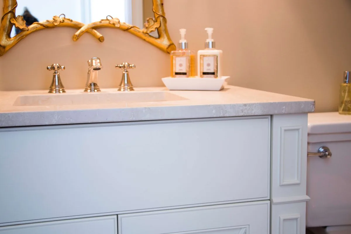 A painted bathroom vanity beside a soaking tub