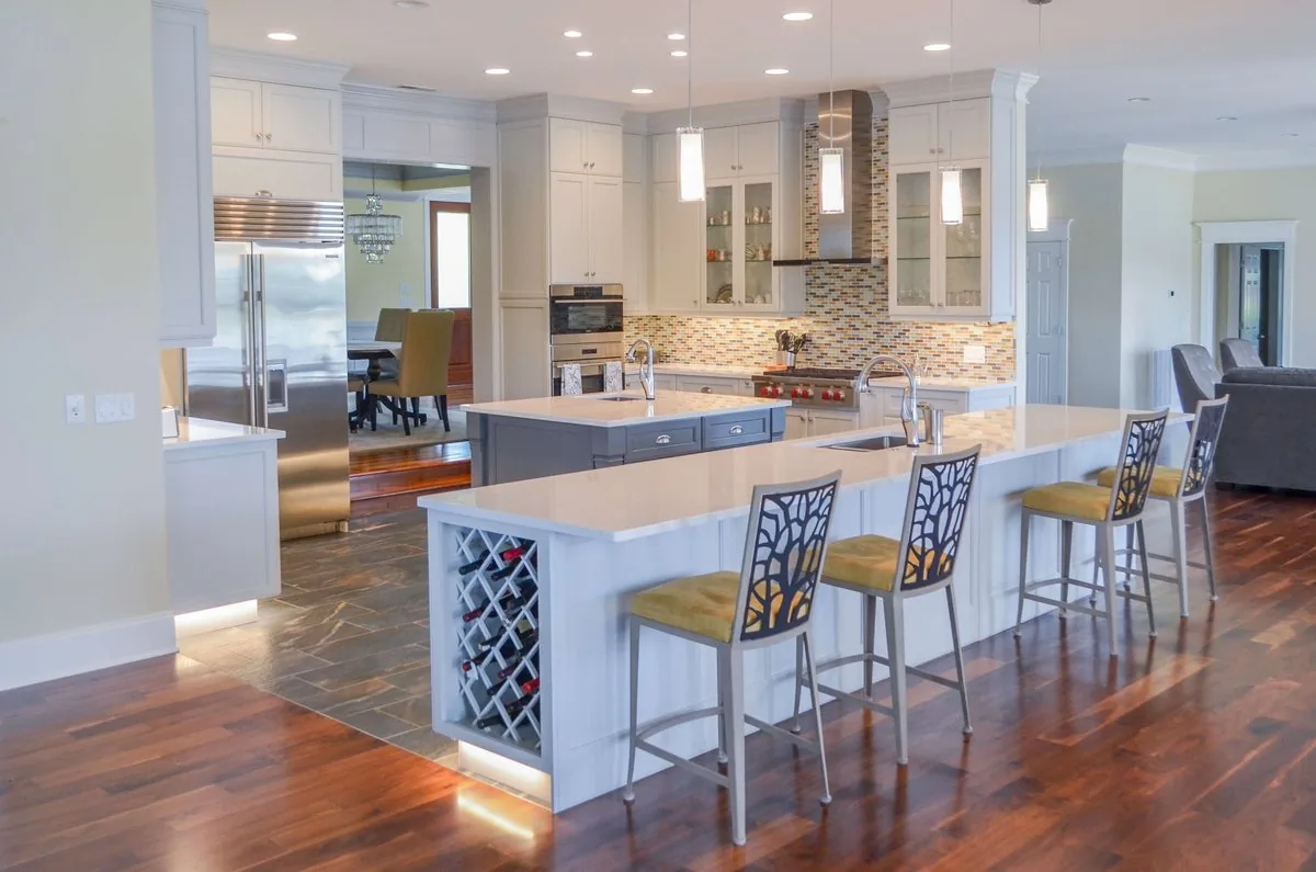 An open kitchen with a wine lattice island and seating