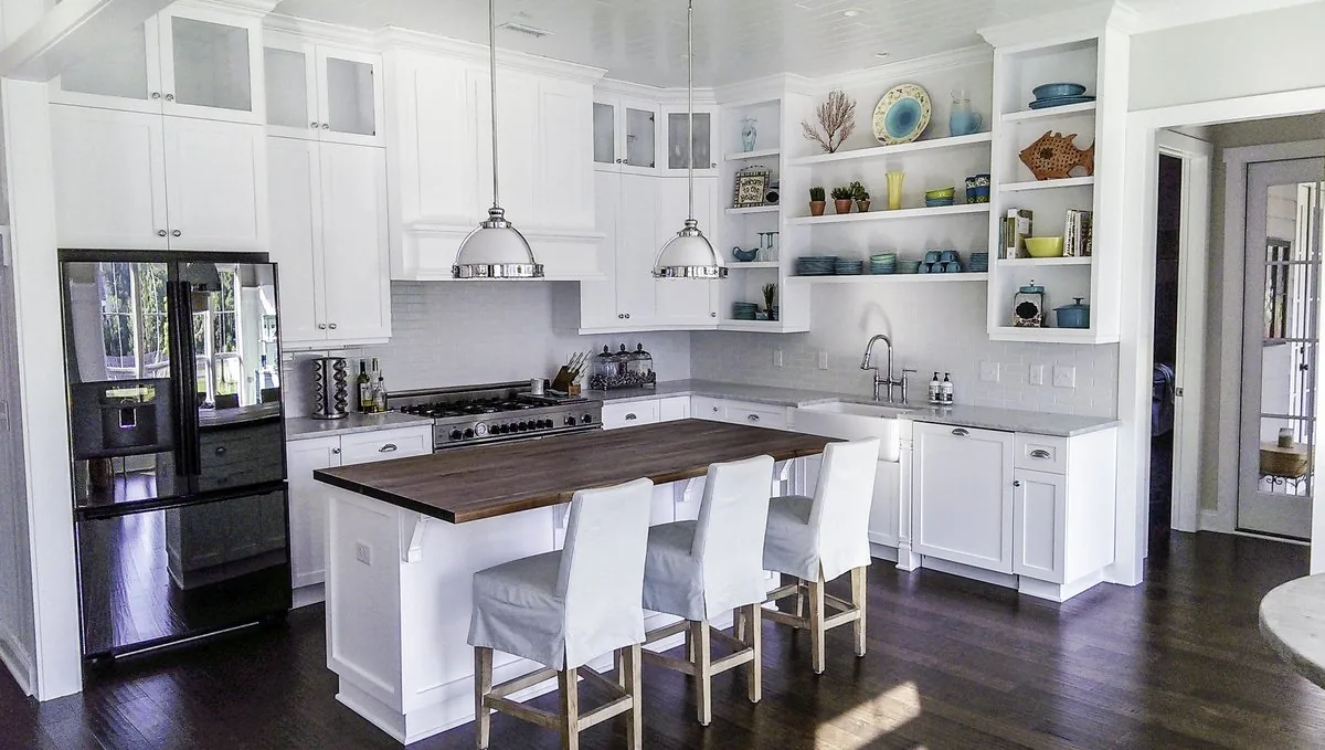 A white kitchen with open shelving and a butcher block island