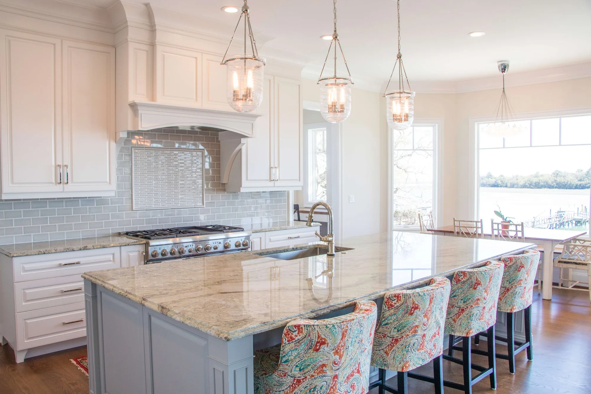 A finished FFT Cabinetry kitchen with a painted island and stone countertop
