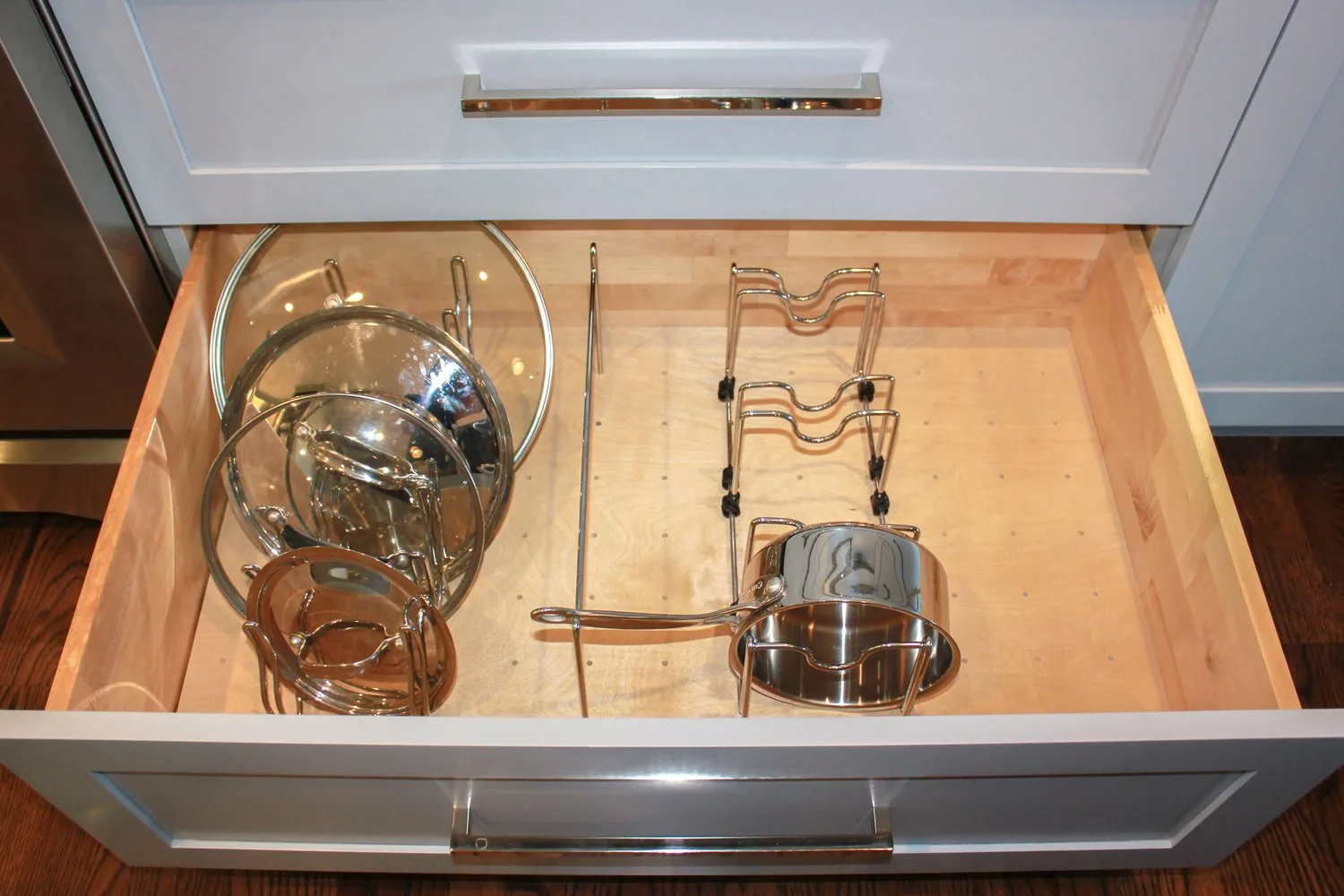 A fitted drawer interior with shaped storage inserts, built by FFT Cabinetry