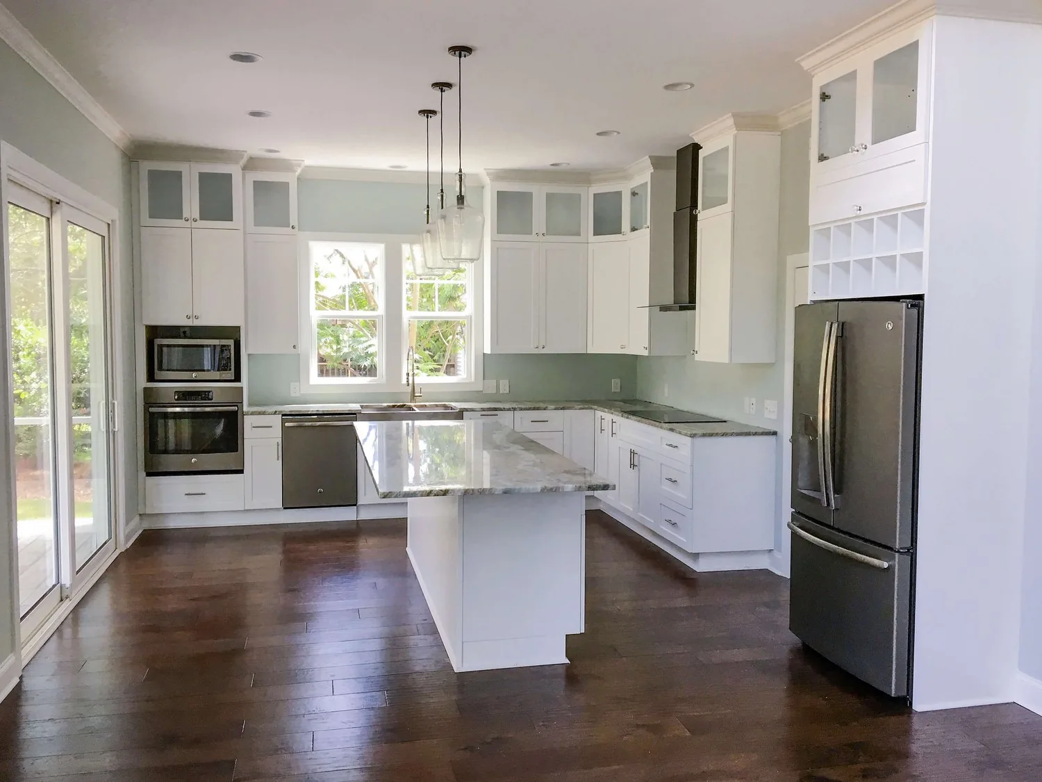 A white FFT kitchen with a full-height pantry wall and a painted island